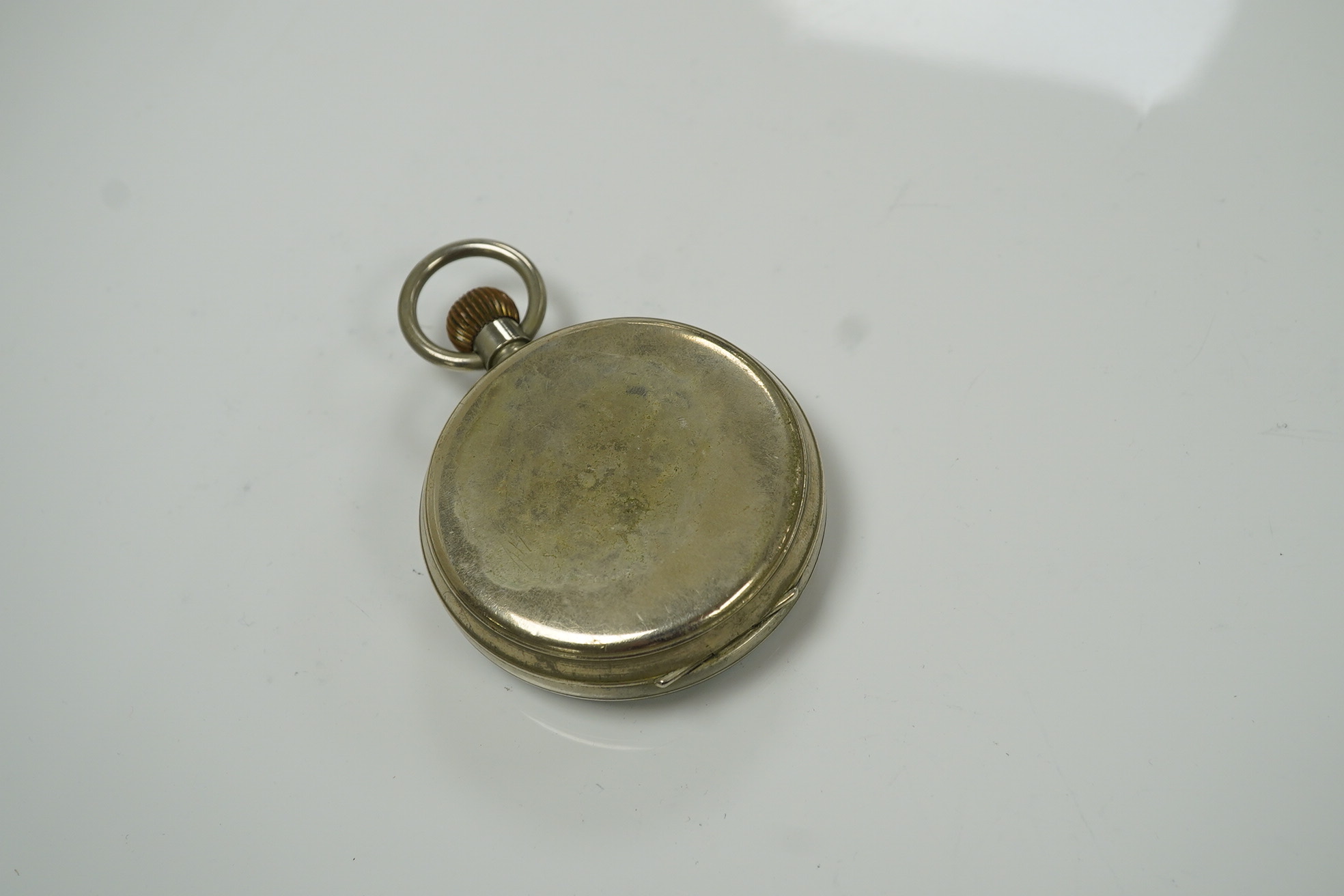 An Edwardian repousse silver mounted travelling watch case, maker W.?, Chester, 1902, 11.1cm, containing a nickel cased pocket watch. Condition - poor to fair